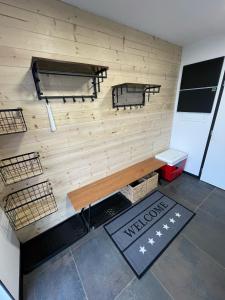 a room with a wooden wall with a bench at Chalet Sijkovsky in Stará Lesná