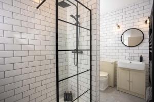 a glass shower in a bathroom with a sink at The Weights and Measures Office in Berwick-Upon-Tweed