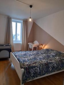 a bedroom with a bed and a table and a window at Maison "Chez Barbara" 6-8personnes in Lalizolle