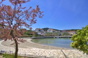 a view of a river with houses in the background at Sandy Beach Studio in Lukoran