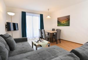 a living room with a couch and a table at Hotel Garni Post in Grainau