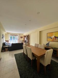 a living room with a wooden table and chairs at Casa Praia Ofir in Esposende
