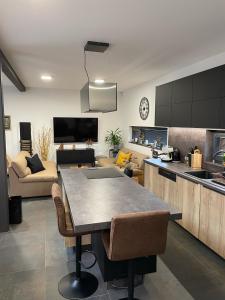 a kitchen and living room with a table and chairs at Chalet Sijkovsky in Stará Lesná