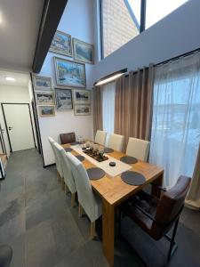 a dining room with a wooden table and chairs at Chalet Sijkovsky in Stará Lesná