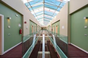 a hallway in a hospital with a glass ceiling at Neo Hotel in Bresso