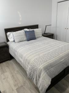 um quarto com uma cama grande com almofadas em Chalets domaine Otis em Saint-Félix-d'Otis