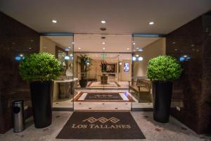 a lobby with two potted plants in a building at Los Tallanes Hotel & Suites in Lima