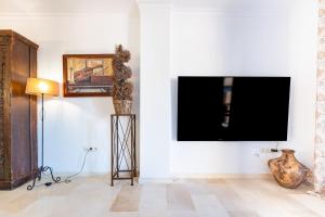 a living room with a flat screen tv on a wall at Los Lagos Golf II Charming 3 bedroom apartment in Marbella in Marbella