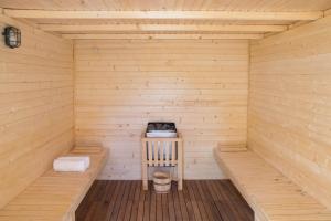 a wooden sauna with a wooden bench in it at Hotel Gran Canaria Princess - Adults Only in Playa del Ingles