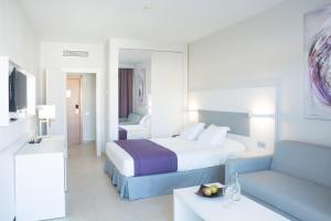 a hotel room with a bed and a couch at Hotel Gran Canaria Princess - Adults Only in Playa del Ingles