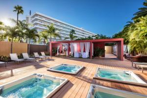 a resort with two hot tubs on a deck at Hotel Gran Canaria Princess - Adults Only in Playa del Ingles