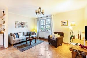 a living room with a couch and a chair at Ferienwohnung an der Schlei in Fleckeby