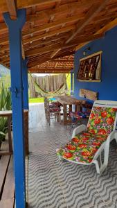 a patio with a chair and a table and a table at Aconchego da Roça in Gonçalves