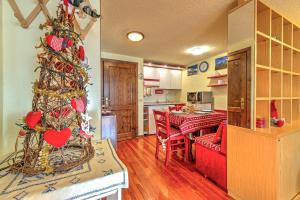 a living room with a christmas tree and a kitchen at APPARTAMENTO CLAIRE - Relax con splendida vista - COUR 0081 in Courmayeur +13 photos
