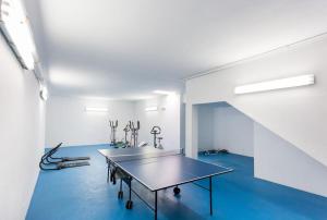 a room with a table on a blue floor at Sea Breeze Lagos Apartment in Lagos