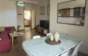 a living room with a table and a couch at Romantic apartment with free parking in Seville