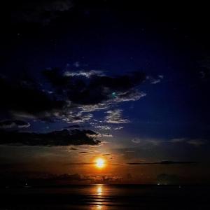 a sunset with the sun in the sky at Tiongman Scubadive & Lodge in Tioman Island