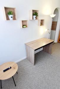 an office with a wooden desk and a table at Larisa Apartment in Cluj-Napoca