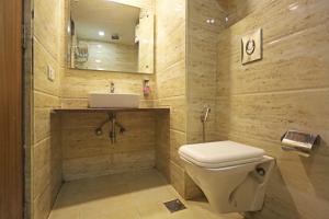 a bathroom with a toilet and a sink at Hotel Grand Suites - Delhi Airport By Dcapitol in New Delhi +85 photos