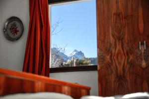 a bedroom with a window with a view of a mountain at Alpine Home - Rooms in Kranjska Gora