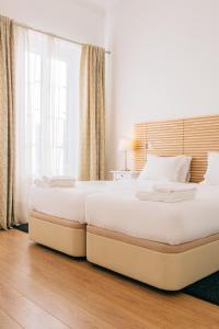 Posteľ alebo postele v izbe v ubytovaní ORM Catedral & São Bento Apartments