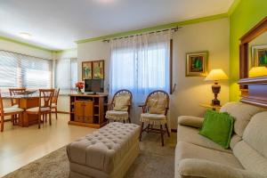 sala de estar con sofá y comedor en Rosa Edificio Di trevi, en Gramado