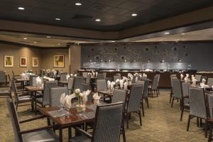 a dining room with tables and chairs and a wall at Candlewood Suites - Cleveland South - Independence by IHG in Independence