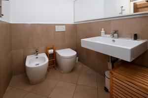 a bathroom with a sink and a toilet at Residenze Romanae - Sangallo Rooms in Rome
