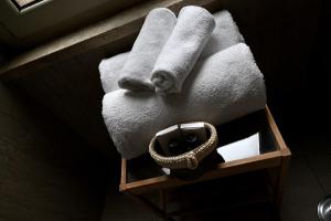 une pile de serviettes sur une étagère dans une salle de bains dans l'établissement Residenze Romanae - Vicolo 22, à Rome