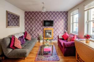a living room with two couches and a tv at Argyll Apartments - Drimvargie Terrace, Oban in Oban