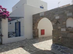 a building with two arches and a stone wall at Silver Rocks Hotel in Chrissi Akti