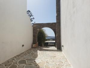 an entrance to a building with a stone walkway at Silver Rocks Hotel in Chrissi Akti