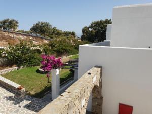a view from the balcony of a house with pink flowers at Silver Rocks Hotel in Chrissi Akti