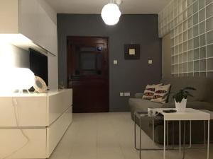 a living room with a couch and a table at studio apartment with pool in house of character. in Birkirkara