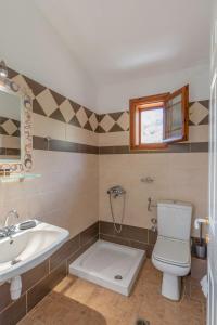 a bathroom with a toilet and a sink at Villa Melina 2 in Koinyra +47 photos