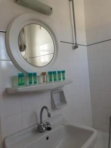 a bathroom with a sink and a mirror at Silver Rocks Hotel in Chrissi Akti