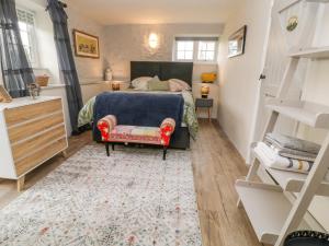 a small bedroom with a bed and a rug at Moohey Barn in Liskeard