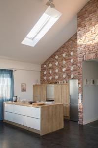 a kitchen with a counter and a brick wall at Alte Flachsfarm in Cottbus