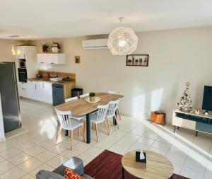 a kitchen and dining room with a table and chairs at Gîte Romarin in Saint-Aignan
