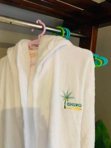 a white shirt with a pineapple on it on a rack at Ishuro Villas in Rukungiri