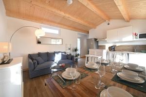 a living room with a couch and a table at MAISONS DE VACANCES LES RÉTHAISES in La Couarde-sur-Mer