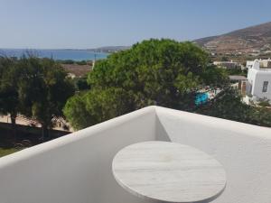 a wooden bench sitting on the edge of a balcony at Silver Rocks Hotel in Chrissi Akti