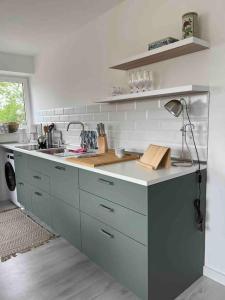 a kitchen with a sink and a counter top at Hafenfewo Weener - Urlaub direkt am Wasser in Weener