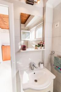 a bathroom with a sink and a mirror at Holiday home Marina-renovated house in city center in Rogoznica