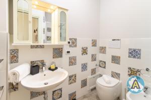 a bathroom with a sink and a toilet and a mirror at Comodo a due passi dal mare 46a in Silvi Paese