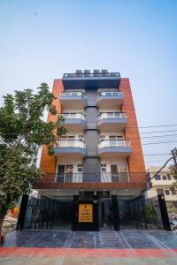 a tall building with a fence in front of it at The Lodgers 1 BHK Serviced Apartment Golf Course Road Gurgaon in Gurgaon