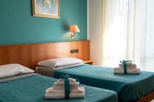 Postel nebo postele na pokoji v ubytování Hotel Alisei