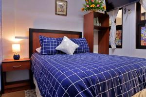 Hotel Posada el Arcangel tesisinde bir odada yatak veya yataklar