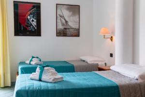 Postel nebo postele na pokoji v ubytování Hotel Alisei