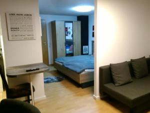 a living room with a bed and a couch at Appartement am Rondell in Hösbach